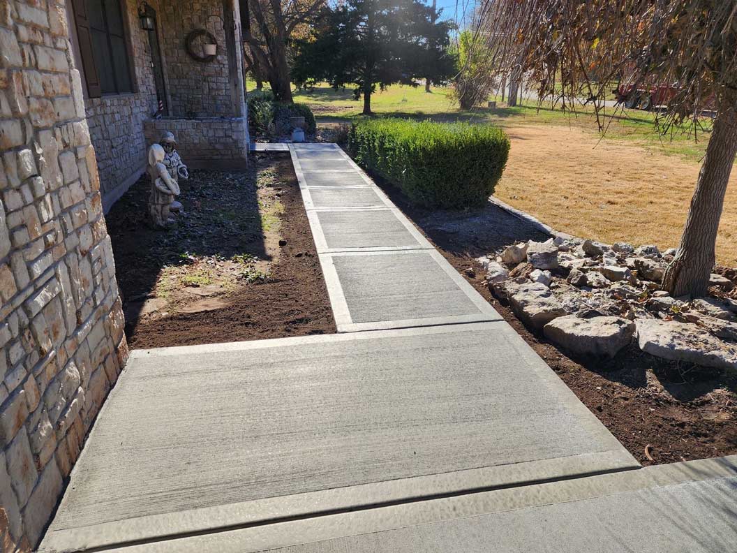 Accessible concrete path from parking to building entry in east KC â€” proper slope and surface