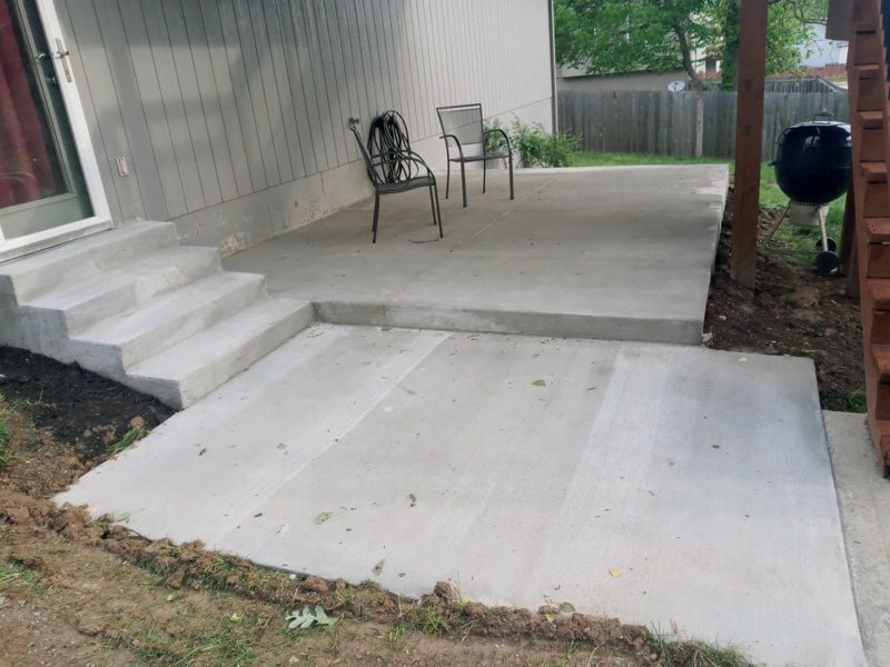 Multi-level concrete patio with retaining steps in Kansas City residential yard