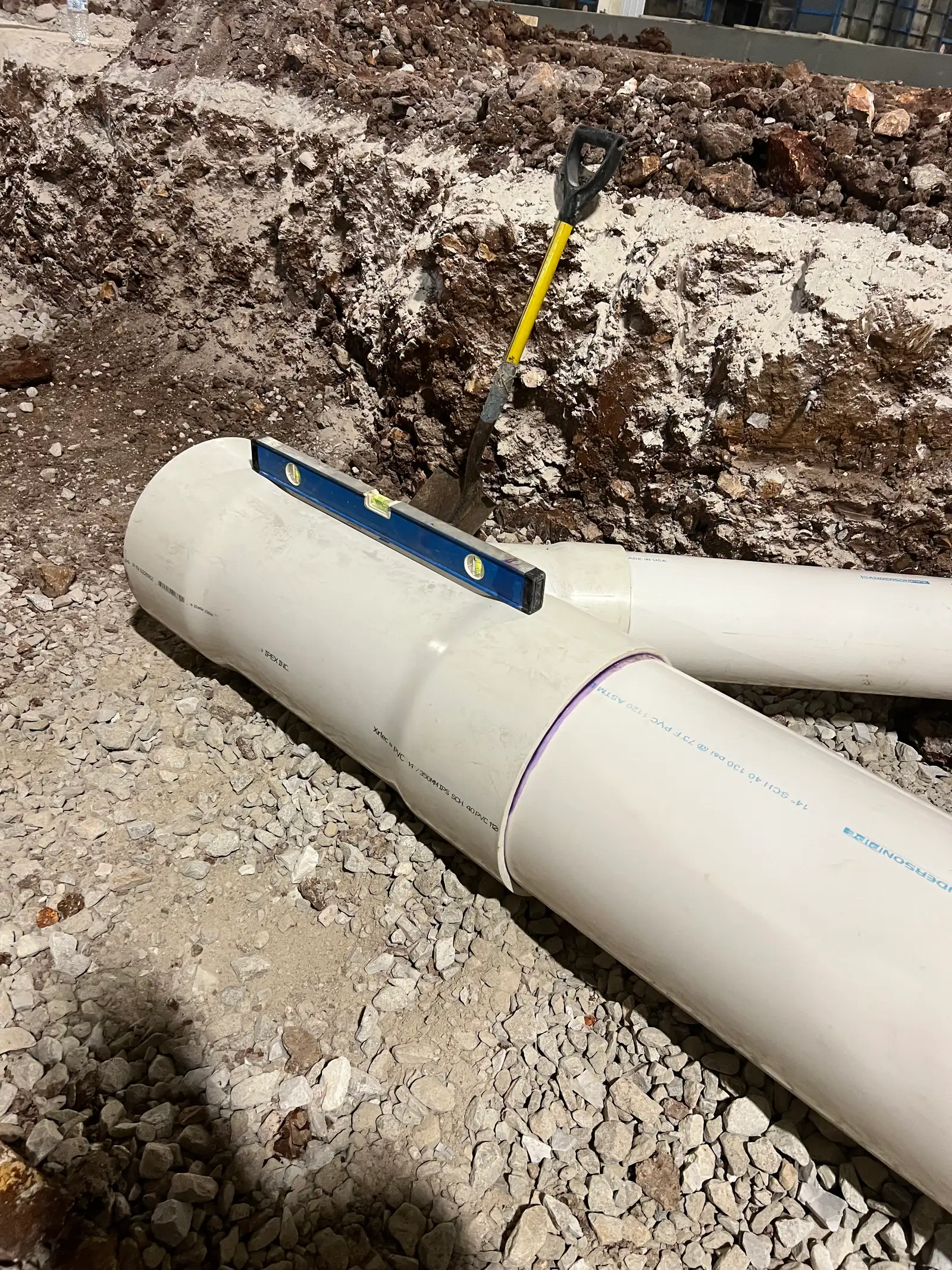 Concrete curb and gutter installation at commercial parking lot in east Kansas City — edge drainage and property definition