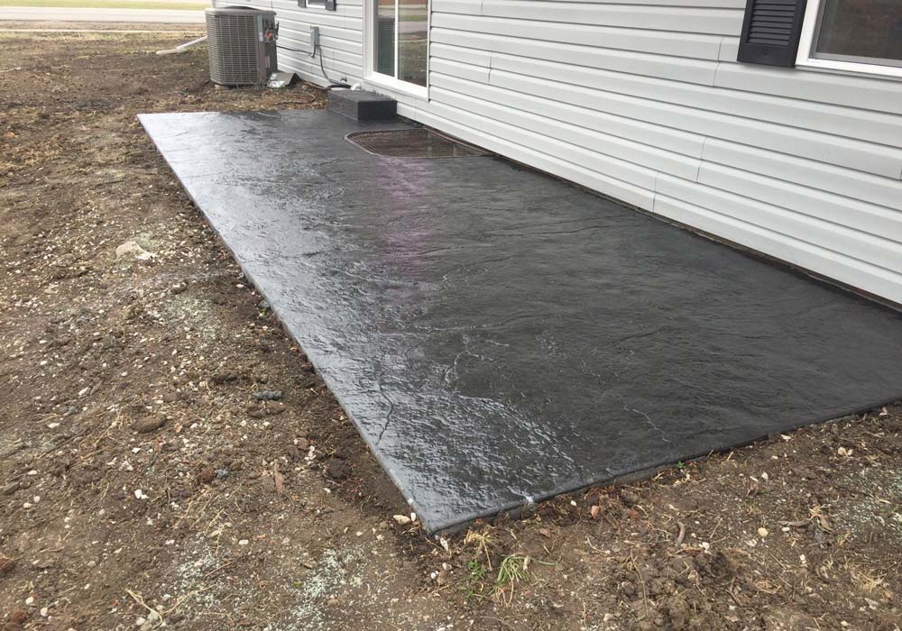 Stamped concrete patio with decorative pattern in Oak Grove â€” finished outdoor living space